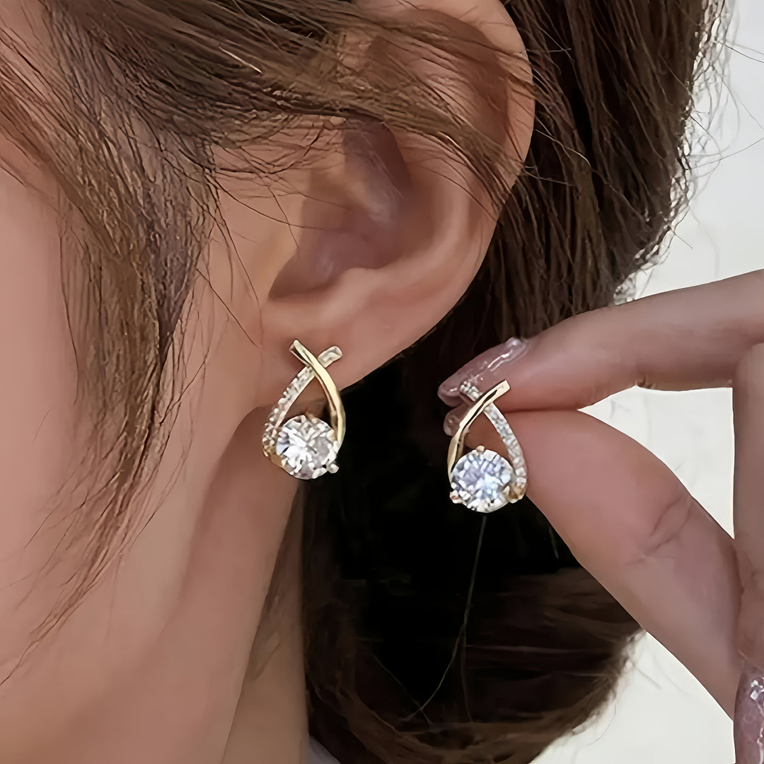 Oorbellen met gouden kruis en zirconium
