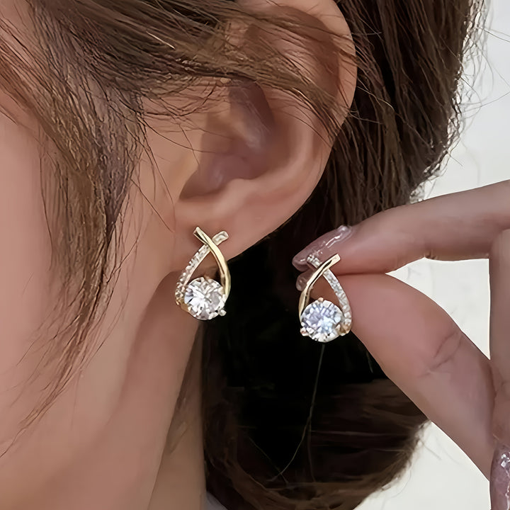 Oorbellen met gouden kruis en zirconium