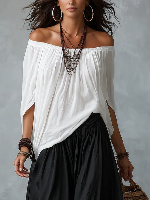 Mara • Set van witte blouse met blote schouders en zwarte palazzo broek