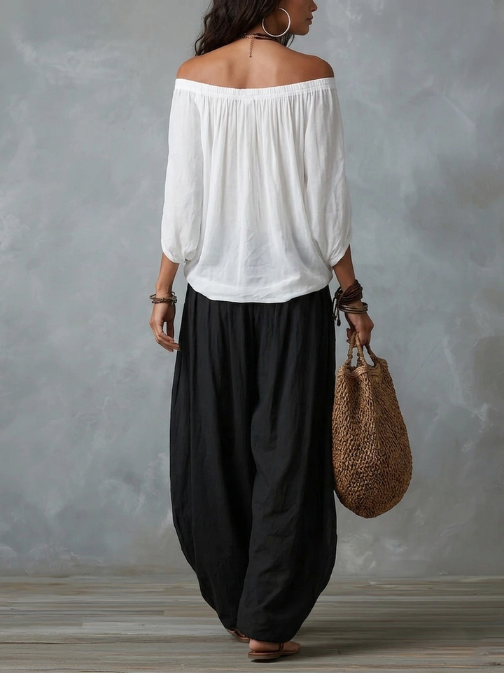 Mara • Set van witte blouse met blote schouders en zwarte palazzo broek