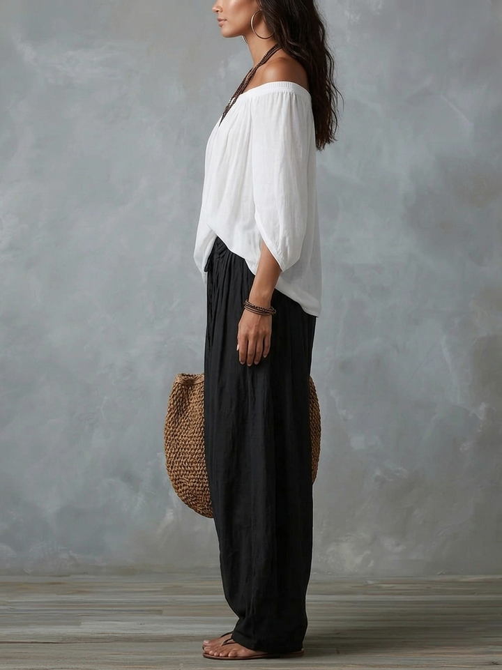 Mara • Set van witte blouse met blote schouders en zwarte palazzo broek