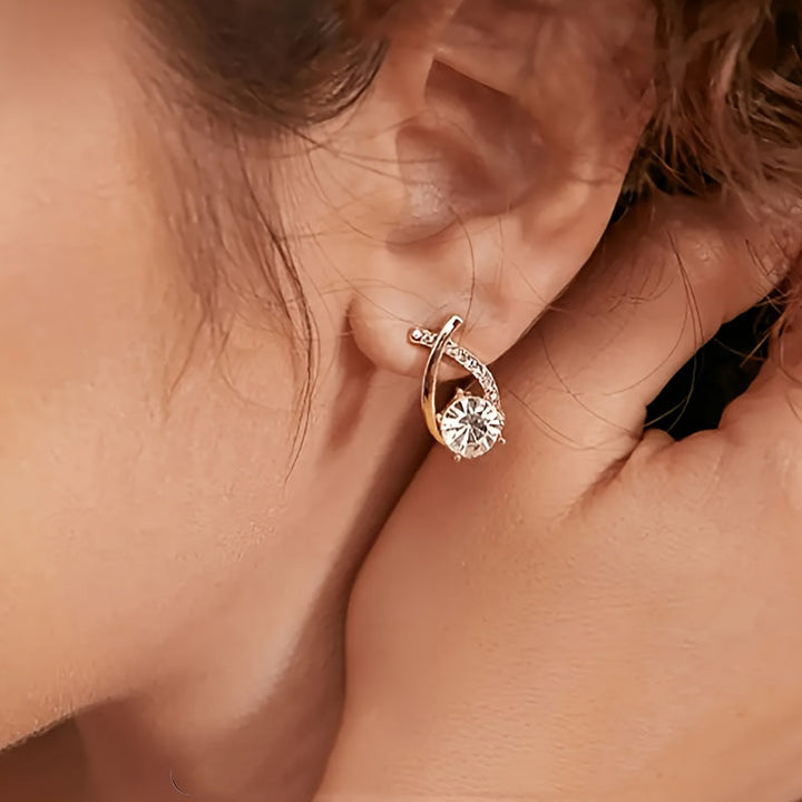 Oorbellen met gouden kruis en zirconium